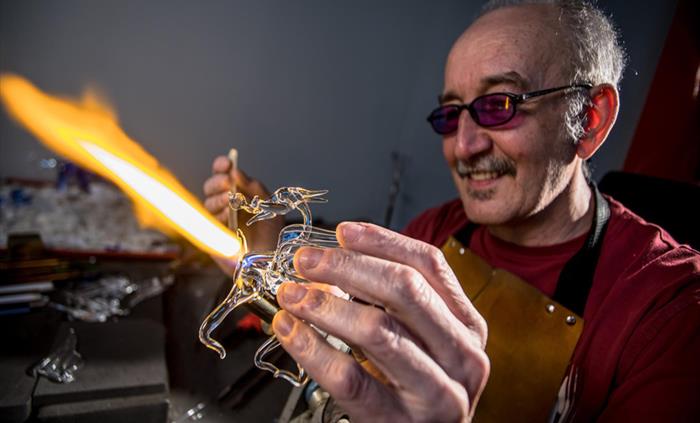 A man making glass dragons